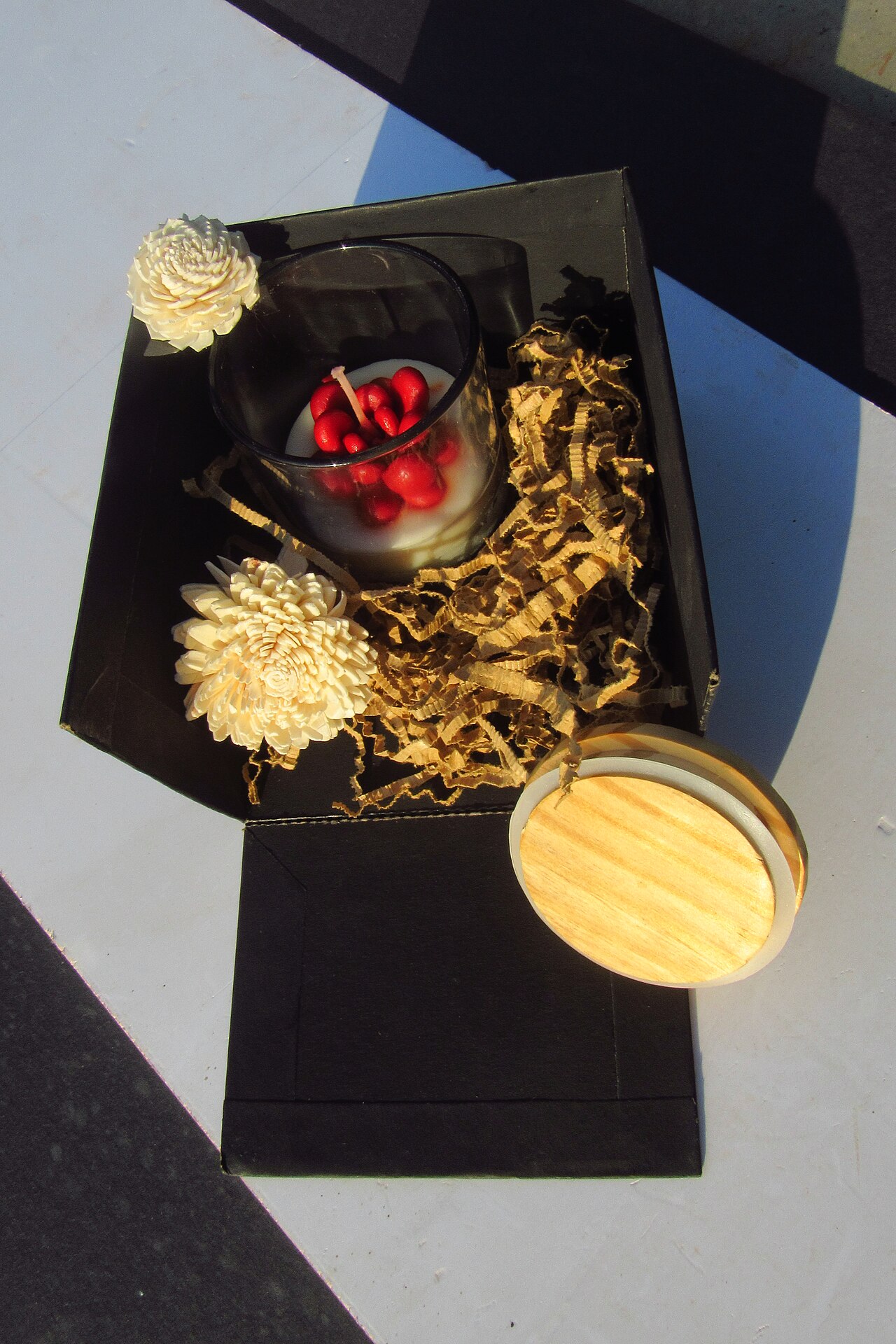 Decorative candle and flowers arranged for a simple self-care gift