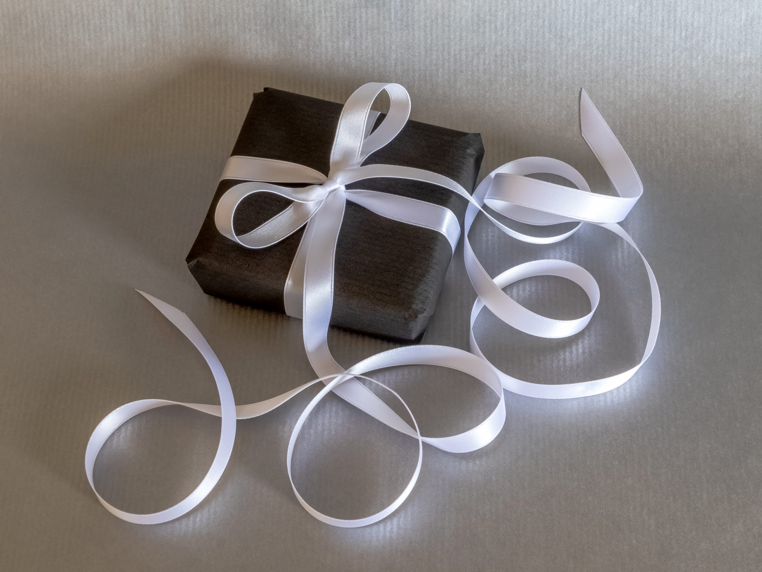 Gift wrapped with long white ribbon for a simple self-care present