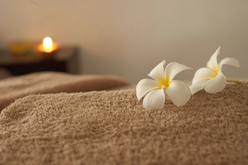 White flower spa scene with soft towels and clean botanical textures for a simple self-care routine