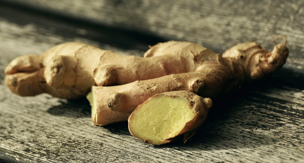 Fresh ginger root on rustic wood in natural light