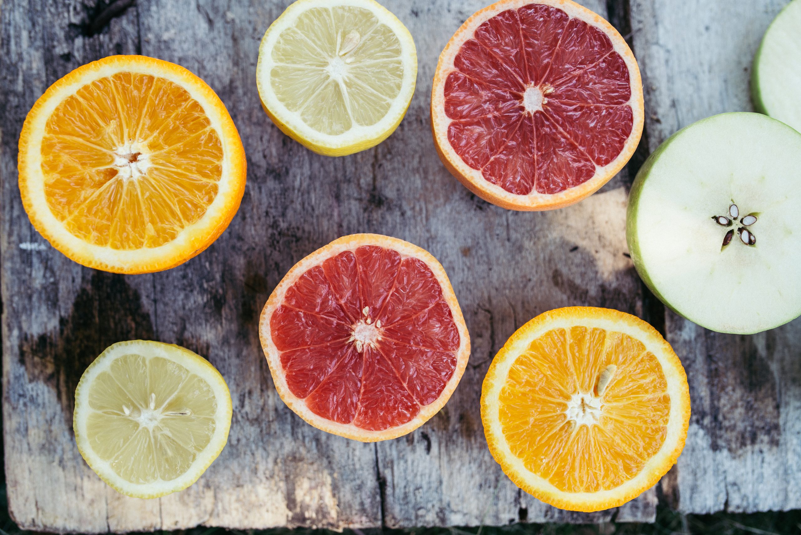 Sliced citrus fruit on a rustic table for a bright summer gift ideas article