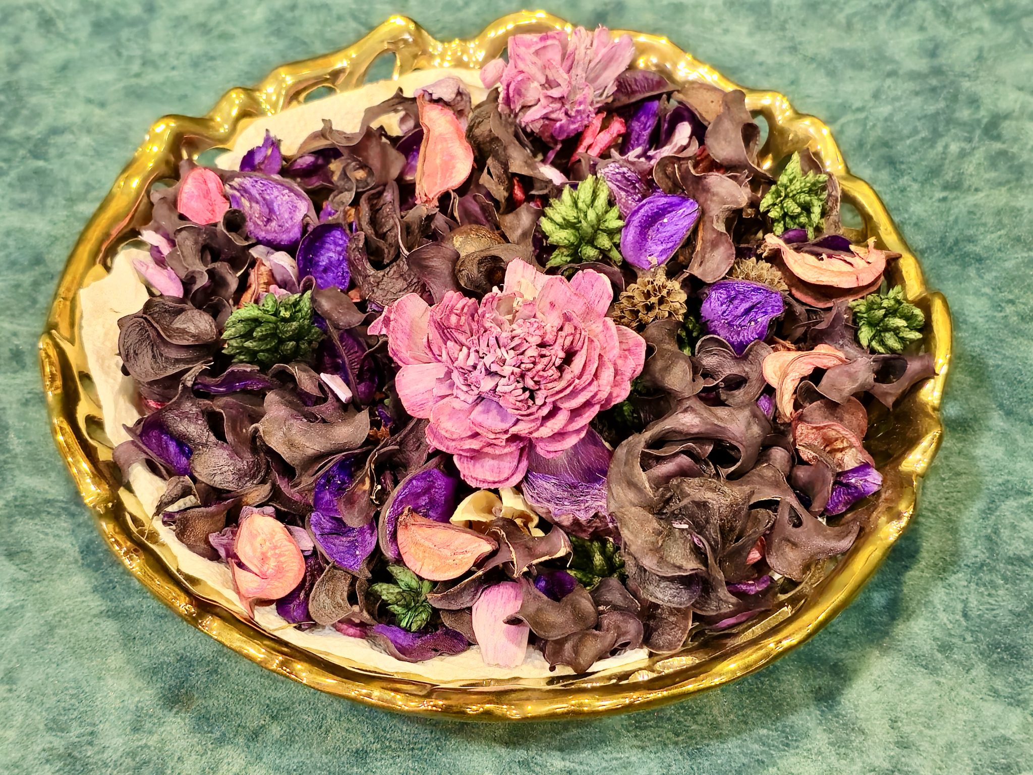 Colourful dried botanicals and flower petals arranged in a decorative bowl