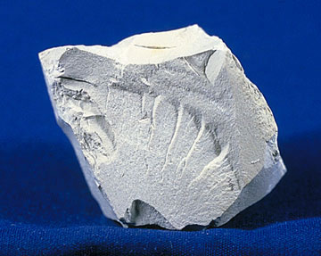 White kaolin clay mineral on a blue background