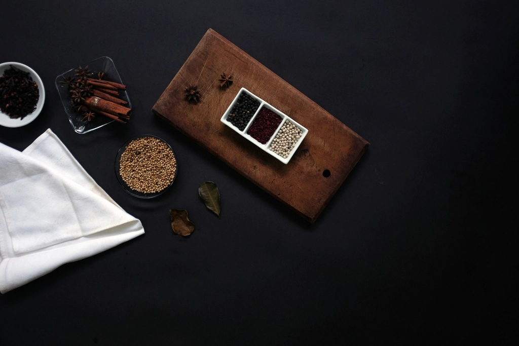 Cinnamon, star anise, peppercorns, and botanicals arranged for a handmade soap scent guide