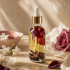Jasmine and rose botanical face and body oil in a warm flower-filled editorial scene